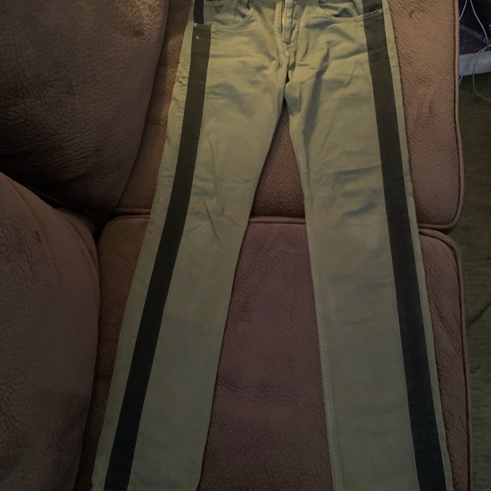 Green Guess jeans with black stripe.